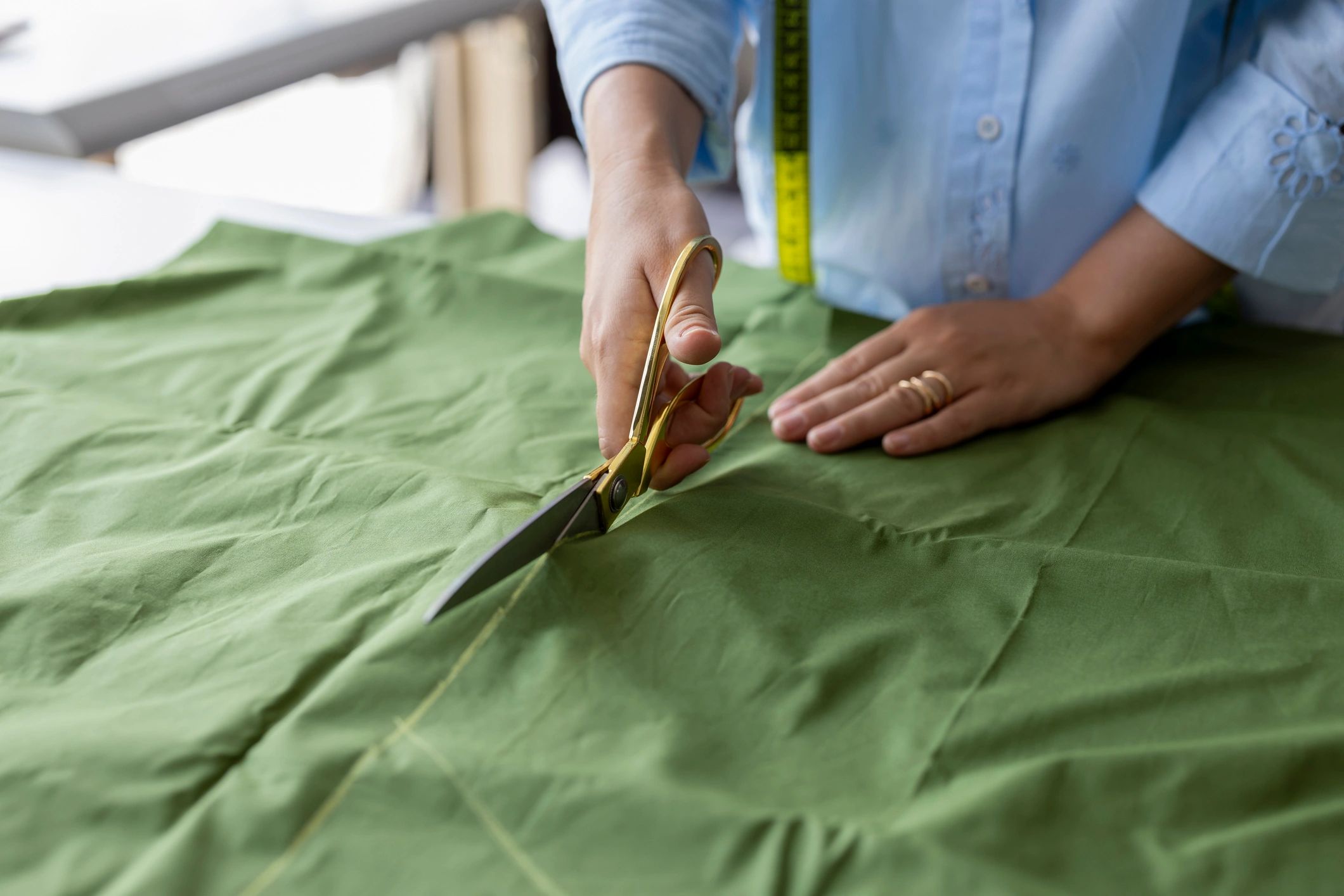 Craftsperson cutting fabric for a custom canvas bag